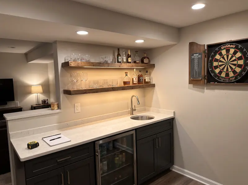 Finished basement wet bar with a small sink and beverage fridge